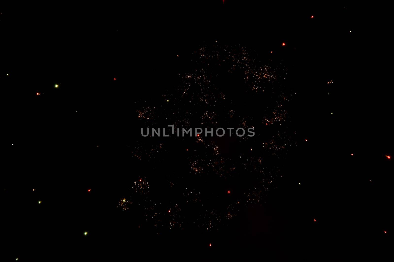 Festive salute in the night sky. Explosions of fireworks and pyrotechnics in the sky.