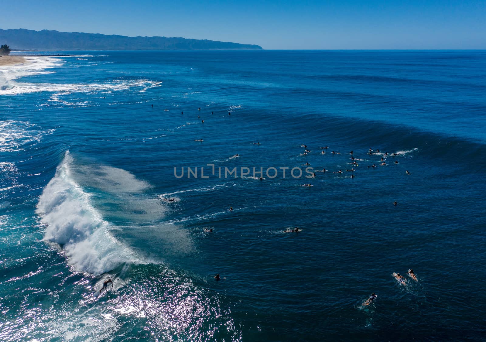 Surfers waiting for the big wave in the sea at Banzai Pipeline on north coast of Oahu, Hawaii