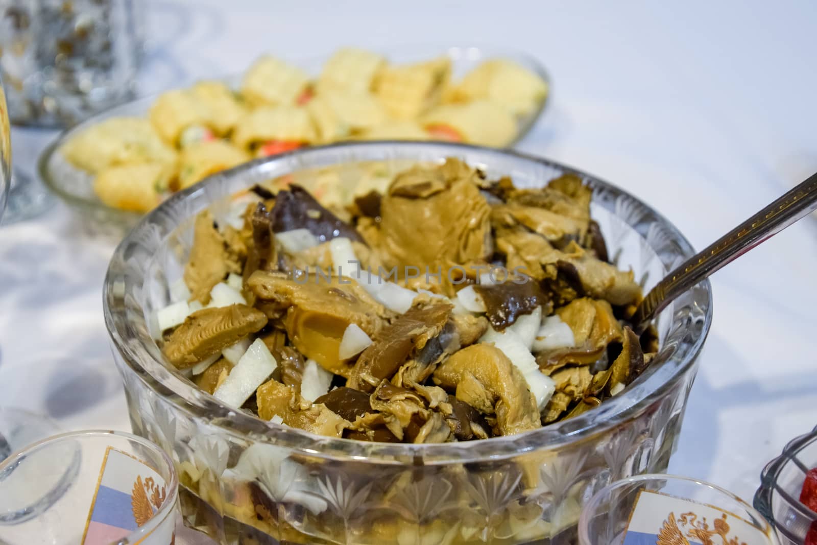 Marinated mushrooms with onions in a crystal cup.
