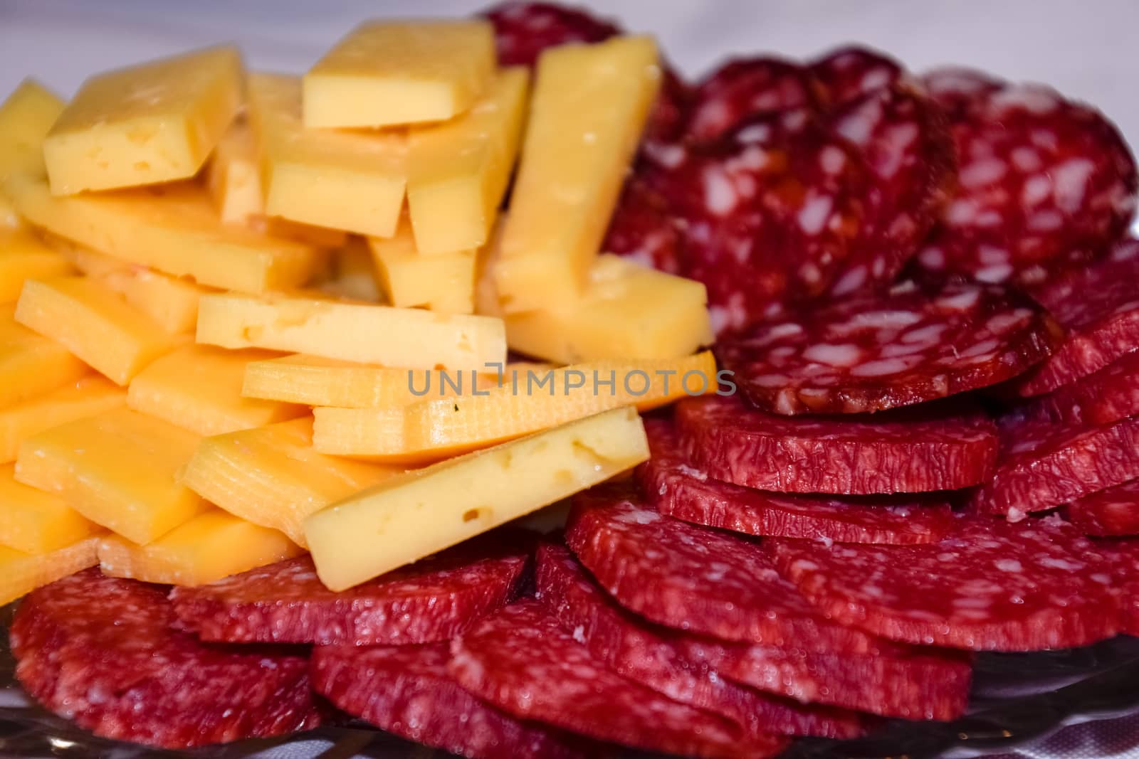 Sausage and cheese on a plate. table setting with sausages and cheeses.