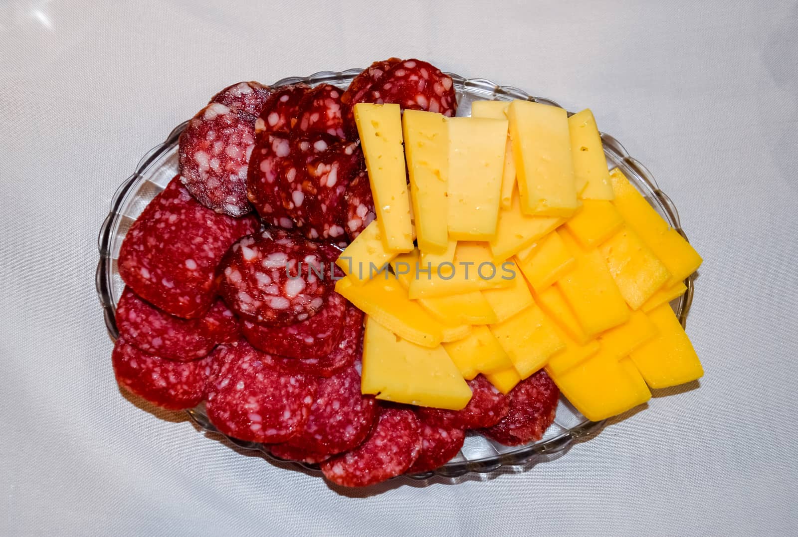 Sausage and cheese on a plate. table setting with sausages and cheeses.