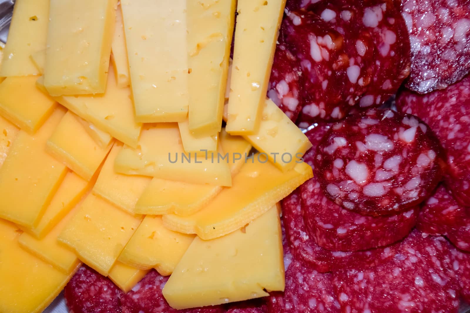 Sausage and cheese on a plate. table setting with sausages and cheeses.