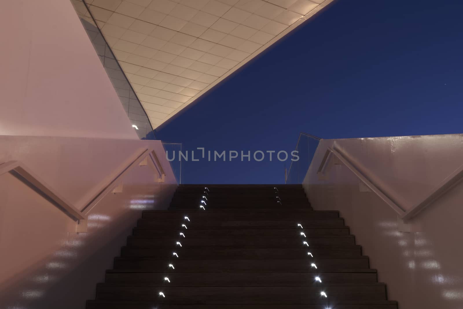 Modernist building, in the blue hour, symmetry, parallel lines, blue, wooden staircase, colors