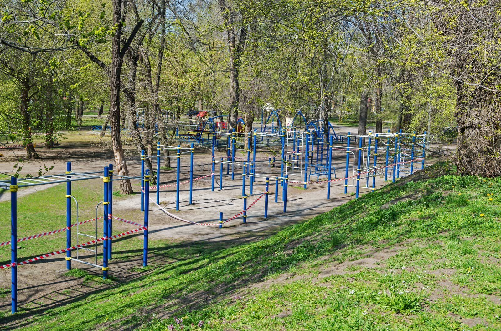 Sports playground in old city park is fenced with barricade tape during COVID-19 coronavirus infection pandemic. It is forbidden to be in public places during quarantine