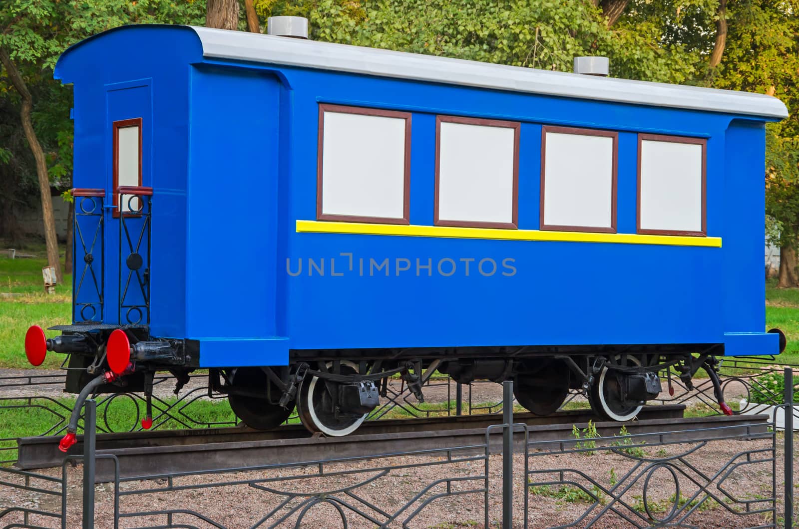 Old passenger train or rail car at outdoors pedestal.