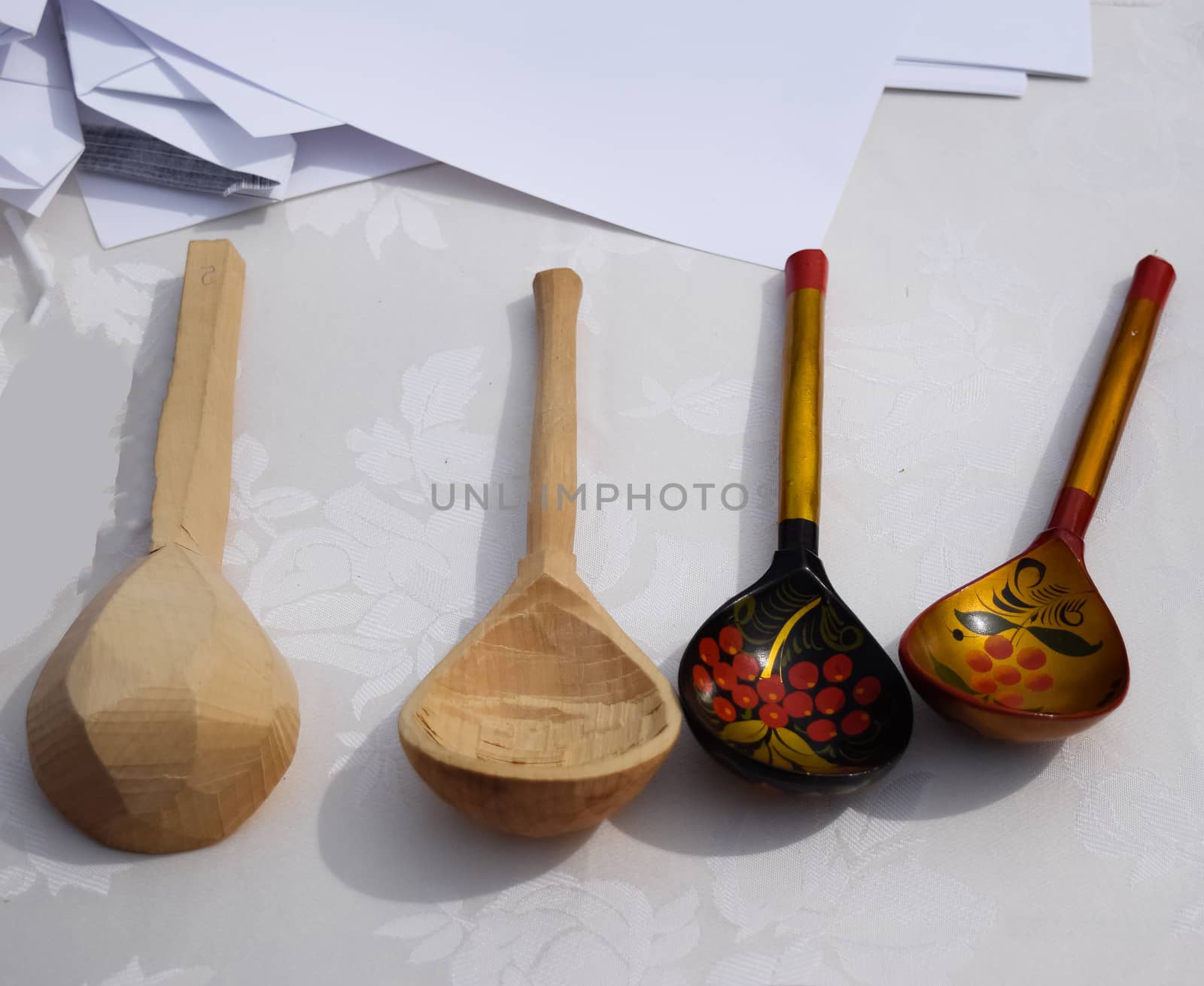 Wooden painted spoons on a white table. National Russian art.