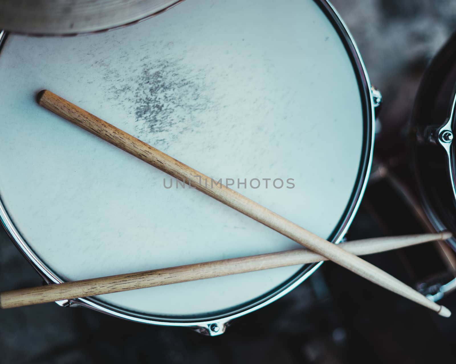 Pretty drummer with drumsticks in an underground environment