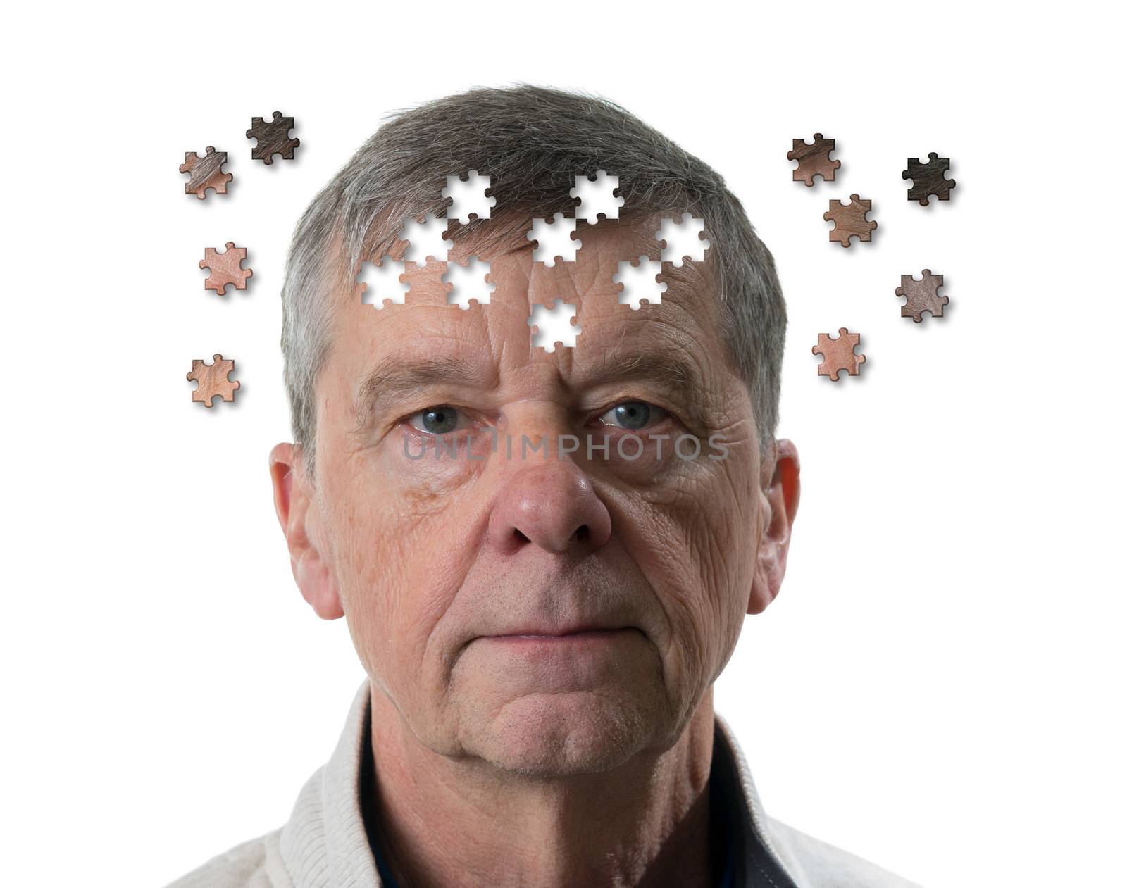 Jigsaw concept of mental illness or dementia with senior caucasian man looking sad into camera by steheap