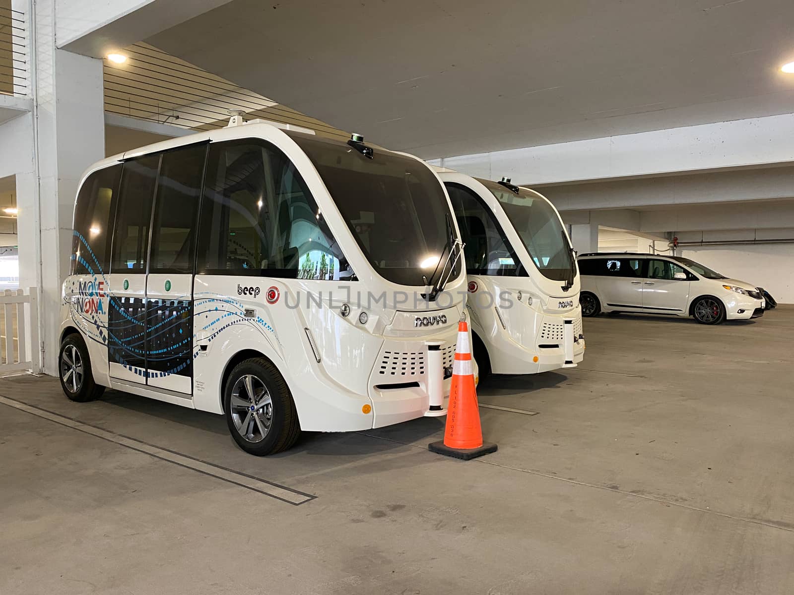 Orlando, FL/USA-4/10/20: Beep shuttles in a parking garage in Laureate Park, Lake Nona, Orlando, FL.   Beep is a shared mobility shuttle that is driverless and autonomous developed by NAVYA.