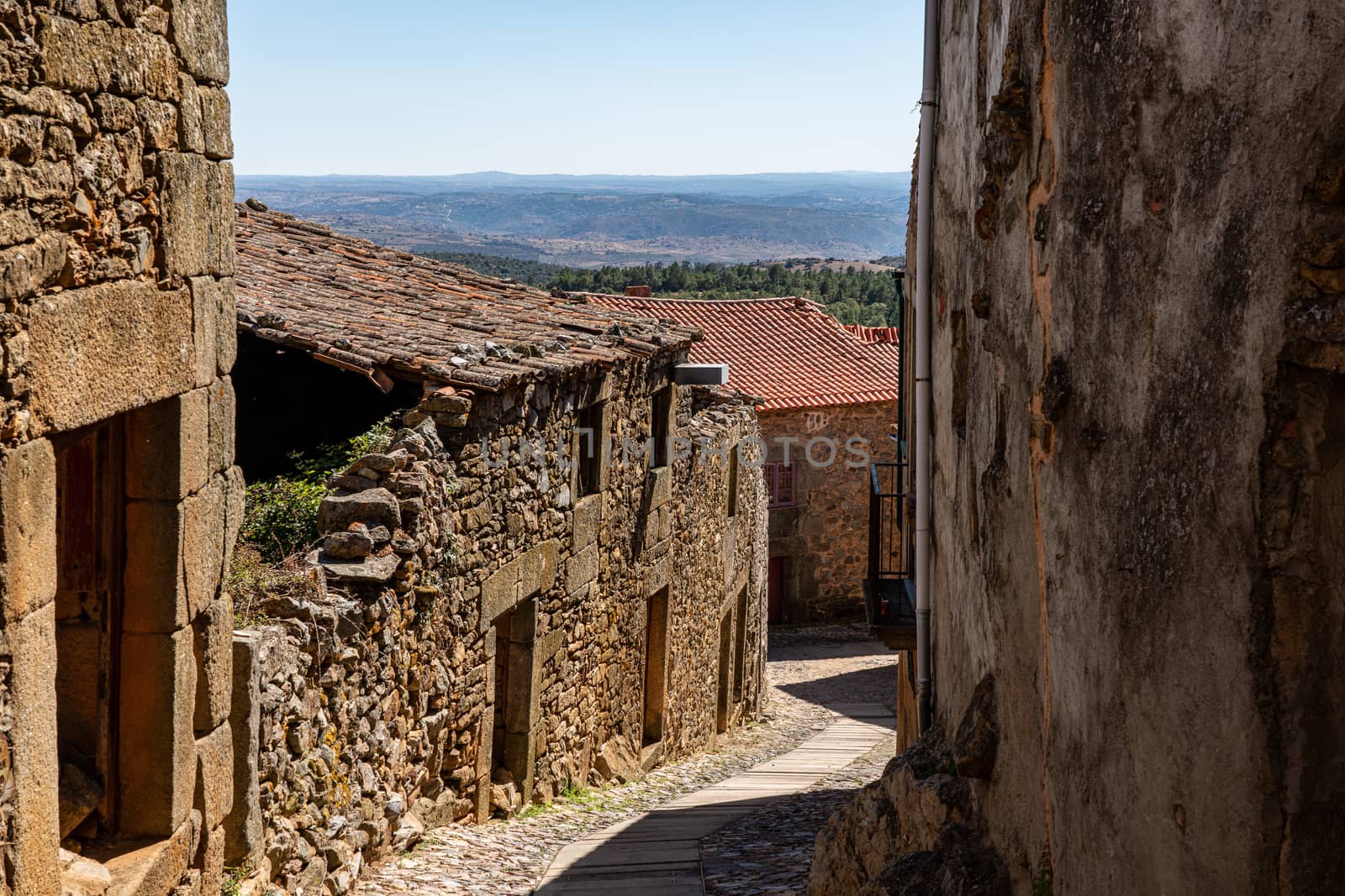 Old stone houses and narrow street in the ancient town of Castelo Rodrigo in Portugal