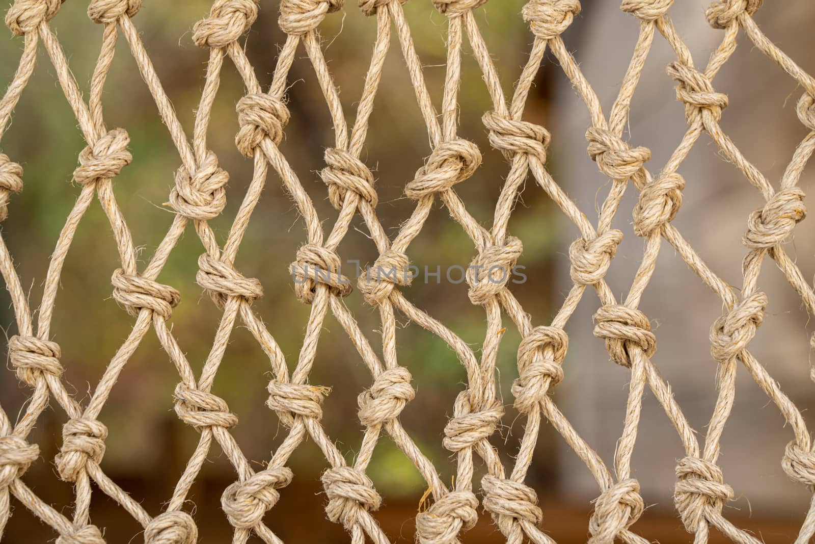 Close up of the knots on a traditional fishing net made by knotting ropes together