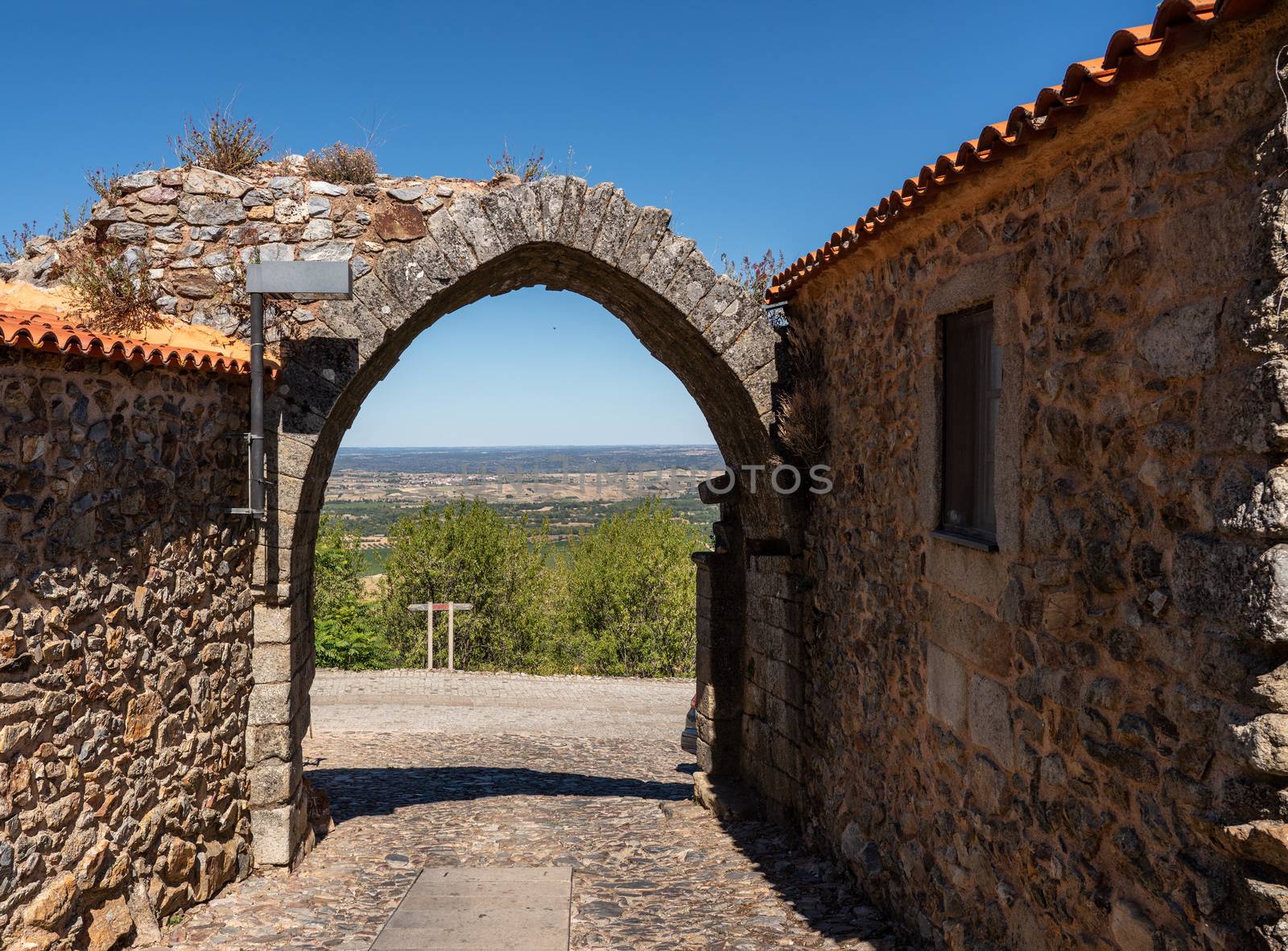 Old stone wall and arch around the houses and narrow streets in the ancient town of Castelo Rodrigo in Portugal