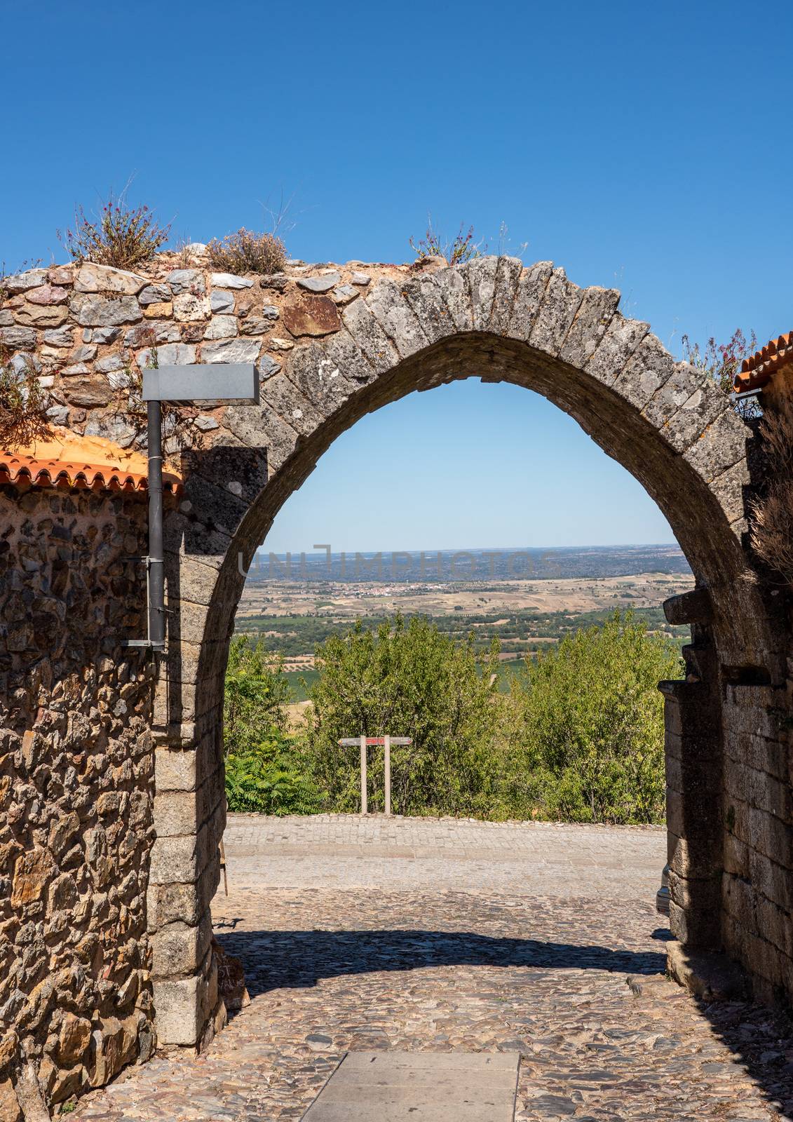 Stone arch in castle wall around Castelo Rodrigo in Portugal by steheap