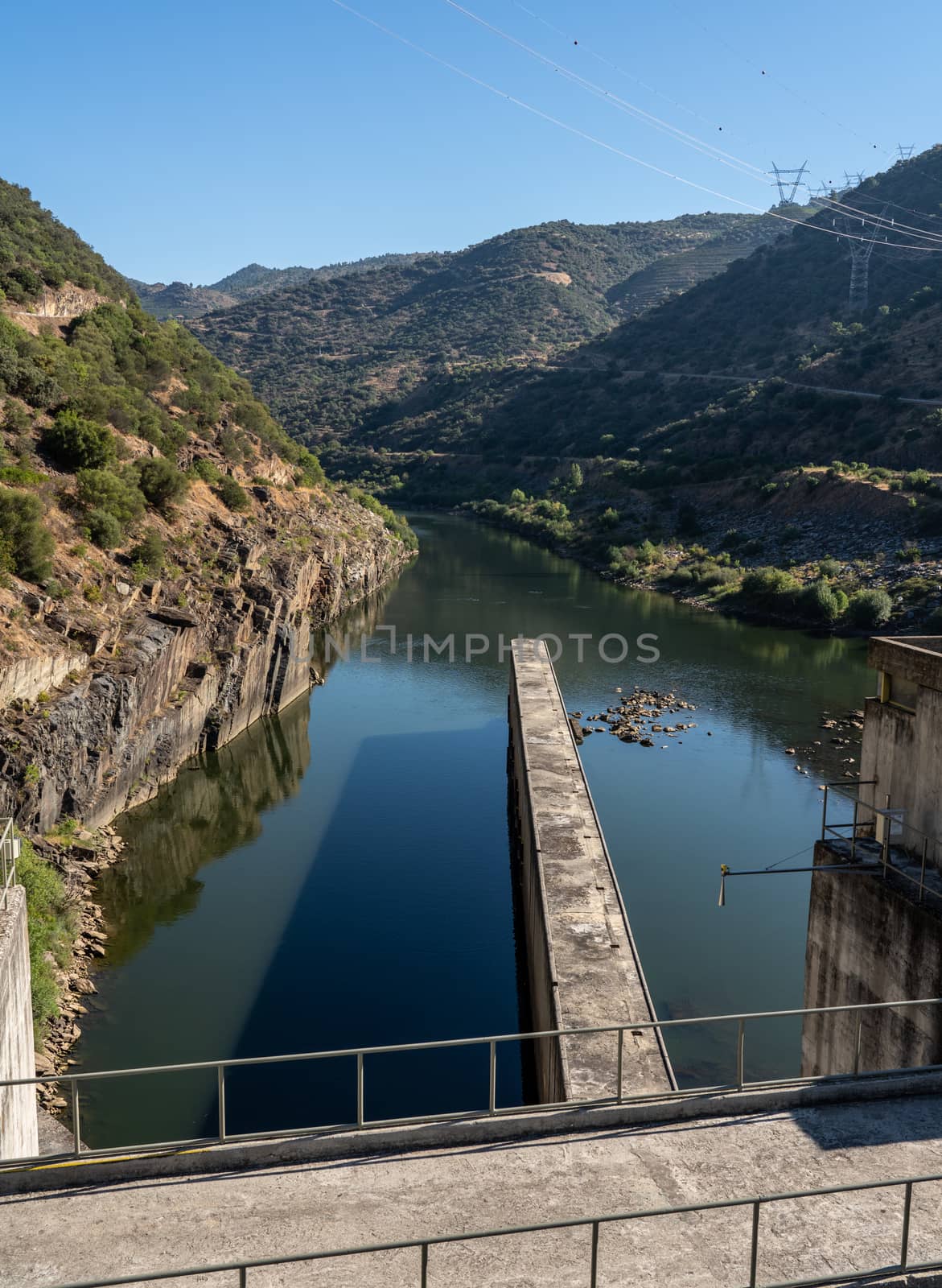 Boat rising inside the lock of the Barragem da Valeira dam on the Douro river by steheap