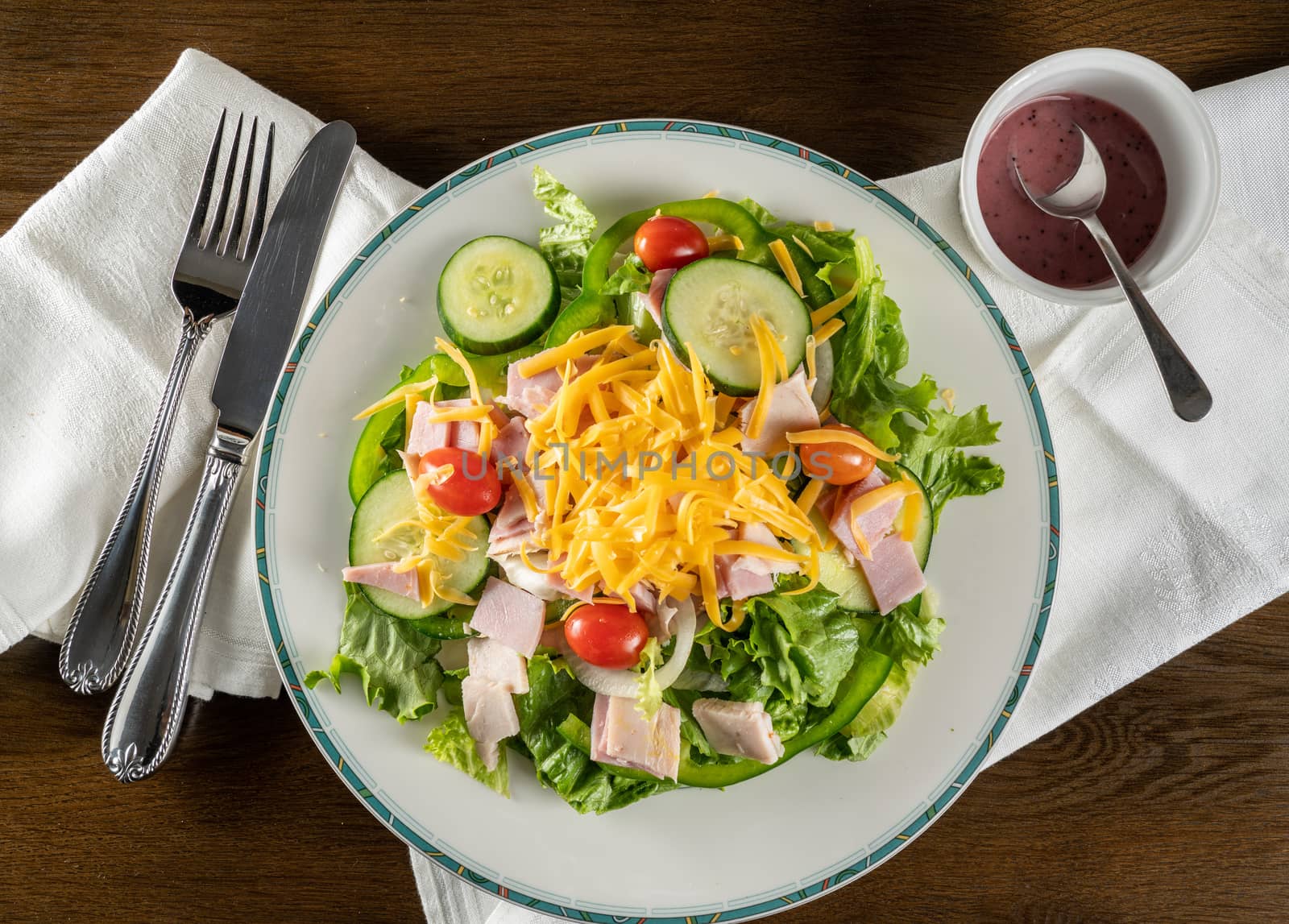 From above view of house or chef salad takeout food plated at home with napkin
