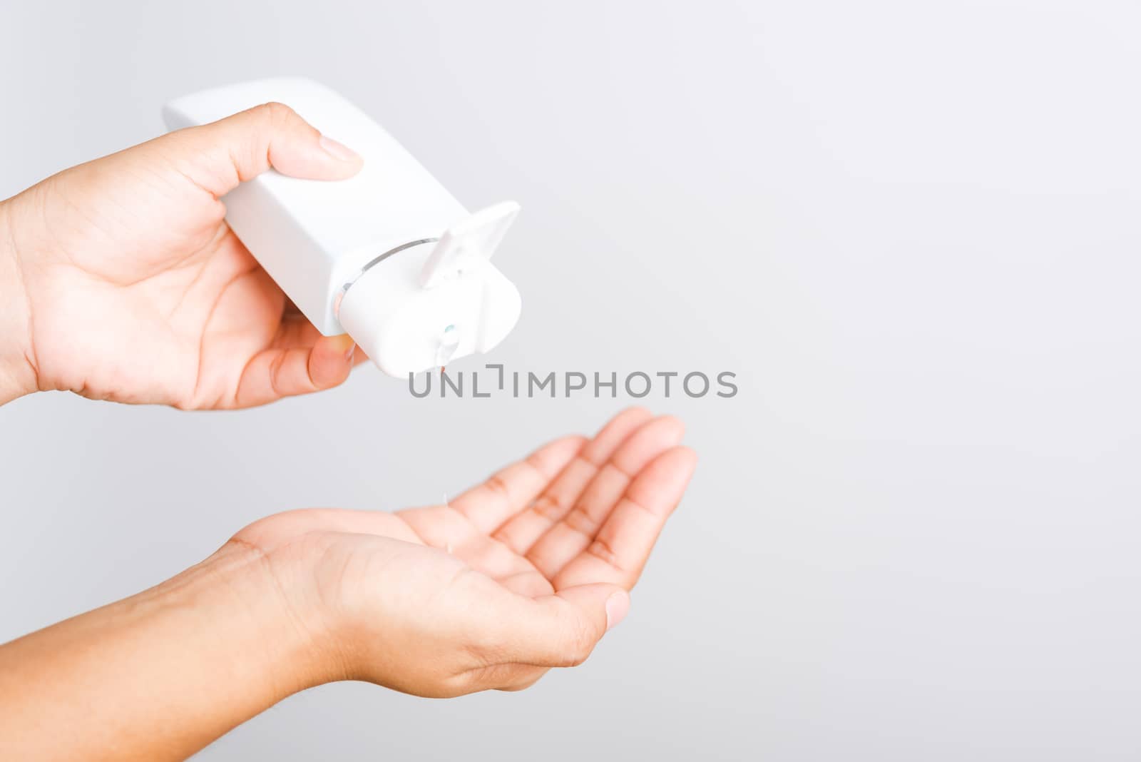 Closeup Hand Asian young woman applying drop dispenser sanitizer alcohol gel on hand wash cleaning, hygiene prevention COVID-19 or coronavirus protection concept, isolated on white background