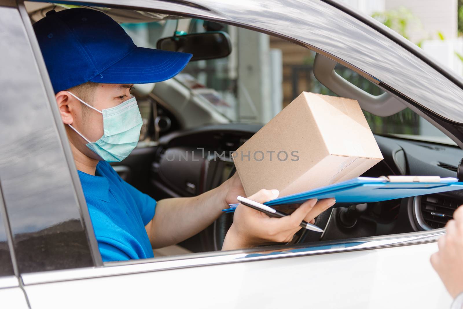 delivery courier young man driver inside van car giving parcel p by Sorapop