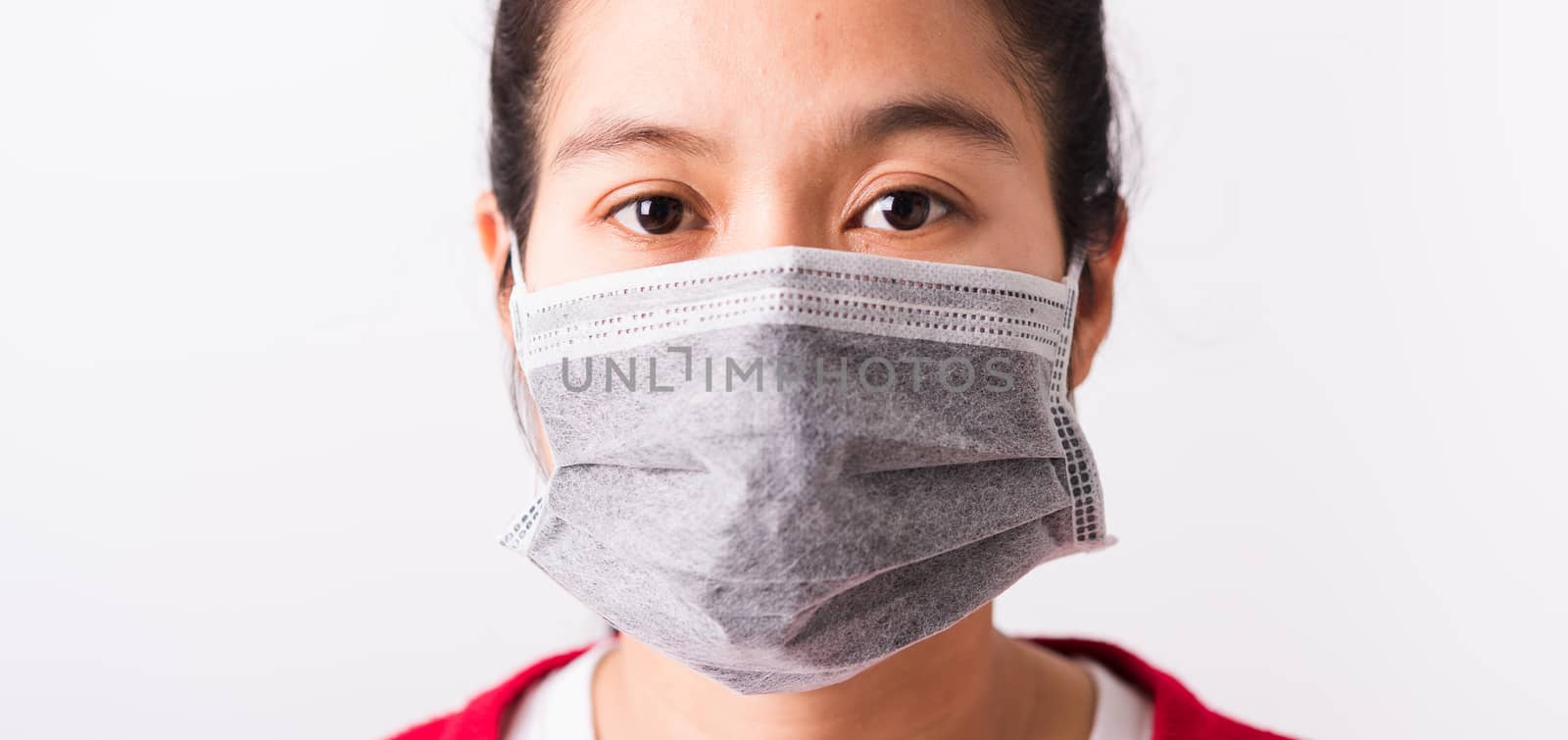 Asian adult woman wearing red shirt and face mask protective against coronavirus or COVID-19 virus or filter dust pm2.5 and air pollution she looking camera, studio shot isolated white background