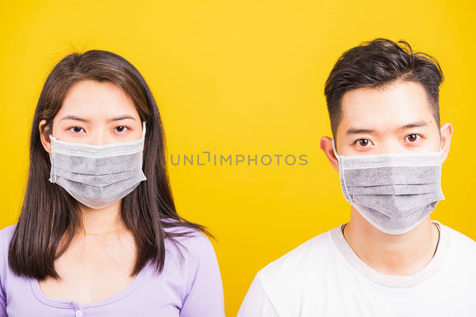 woman and handsome man wearing protection face mask against coro by Sorapop