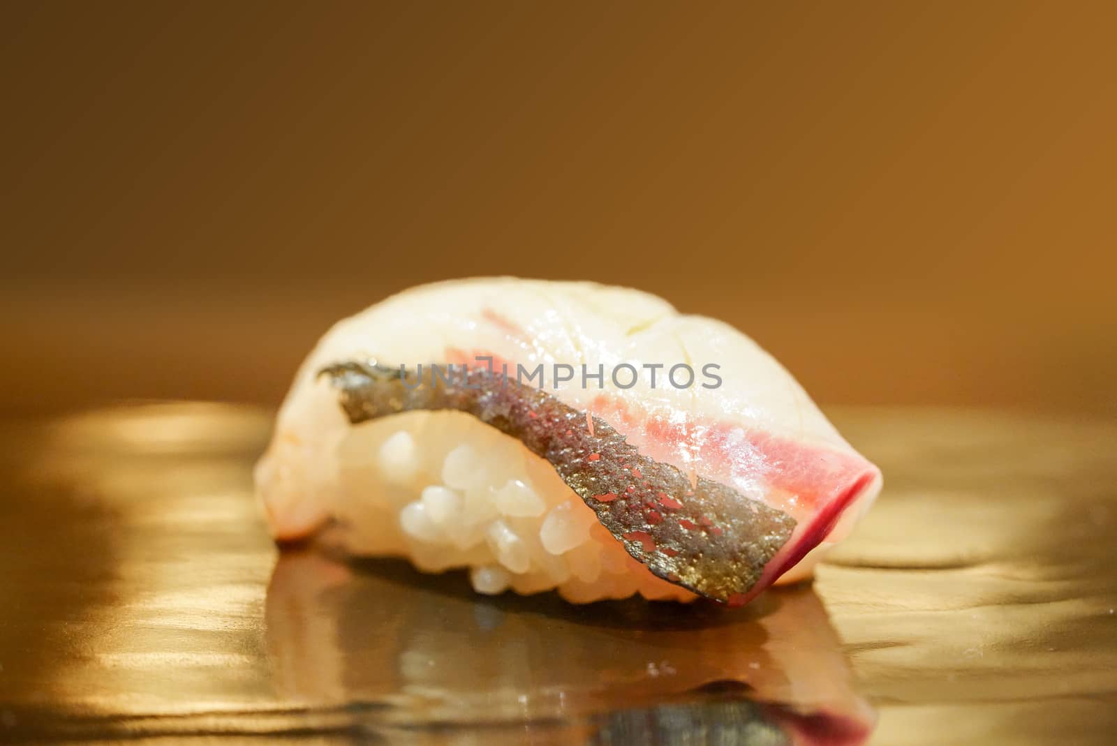 Hamachi Sushi Served on black wooden plate. Japanese Omakase course.