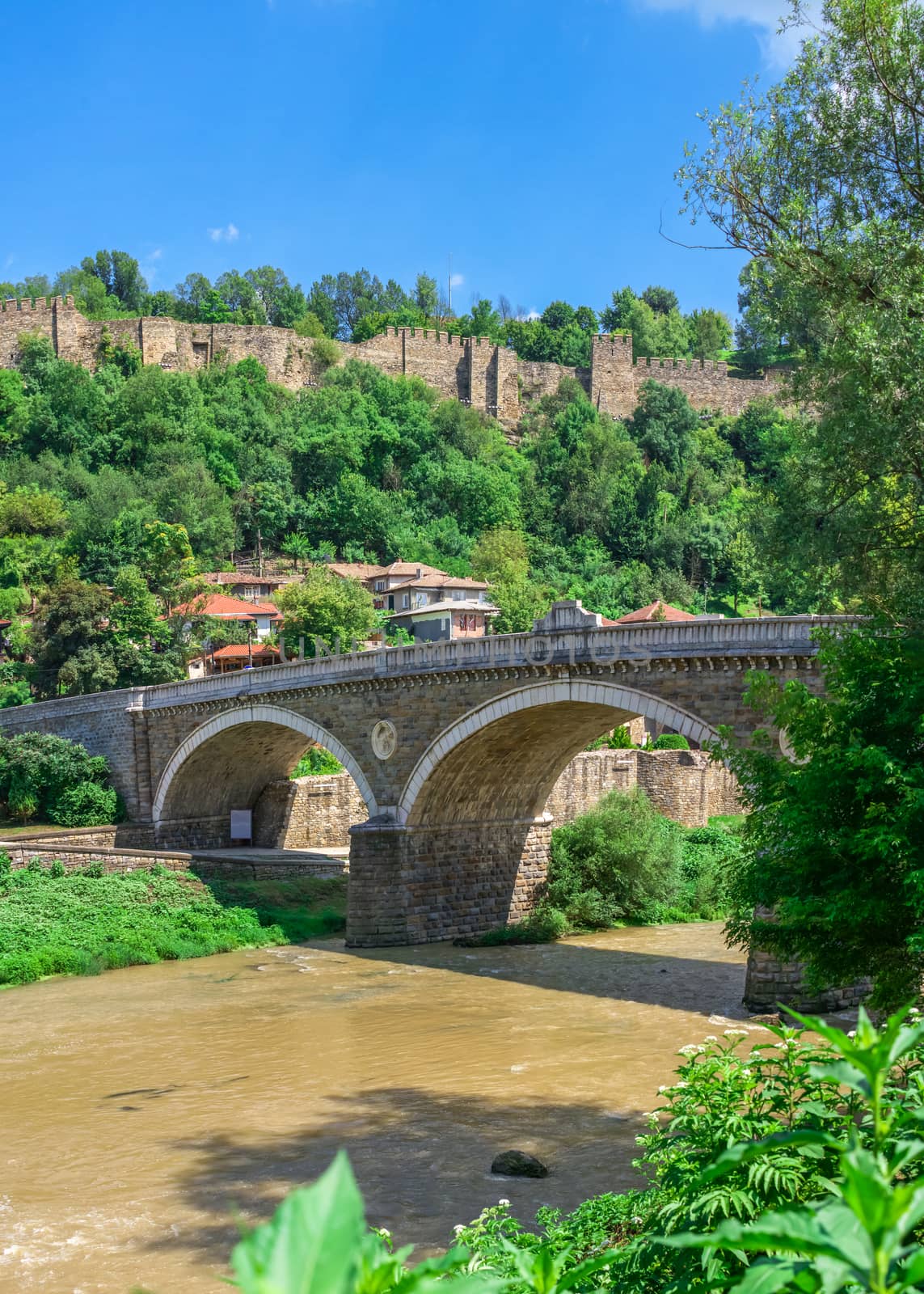 Bridge over the Yantra River near Veliko Tarnovo Fortress, Bulgaria. Hi res panoramic view on a sunny summer day.