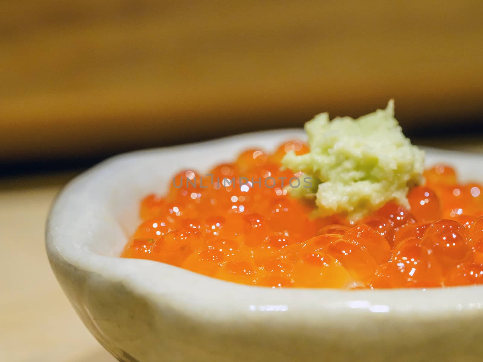 Salmon roe (ikura) with fresh wasabi on the rice bowl. Enjoy Omakase experience at Japanese Sushi Restaurant.