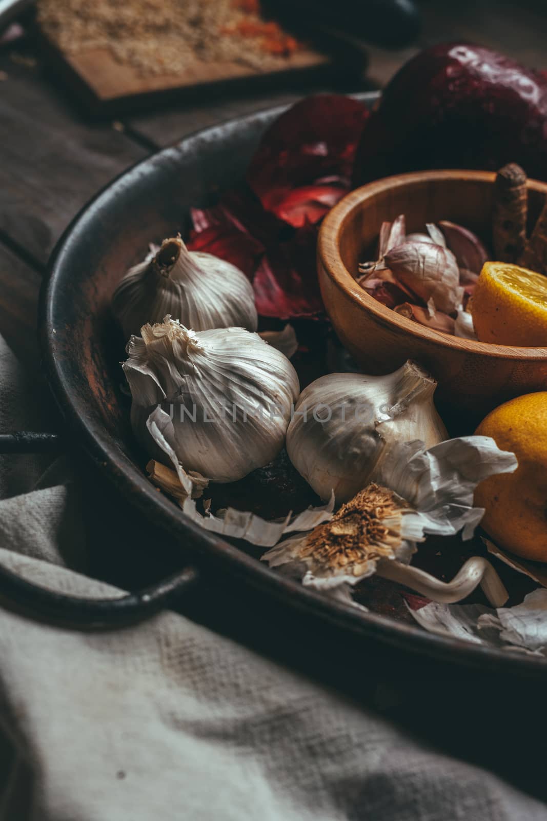 Paella with onion, turmeric, garlic and lemon on a wooden table in a rustic tone