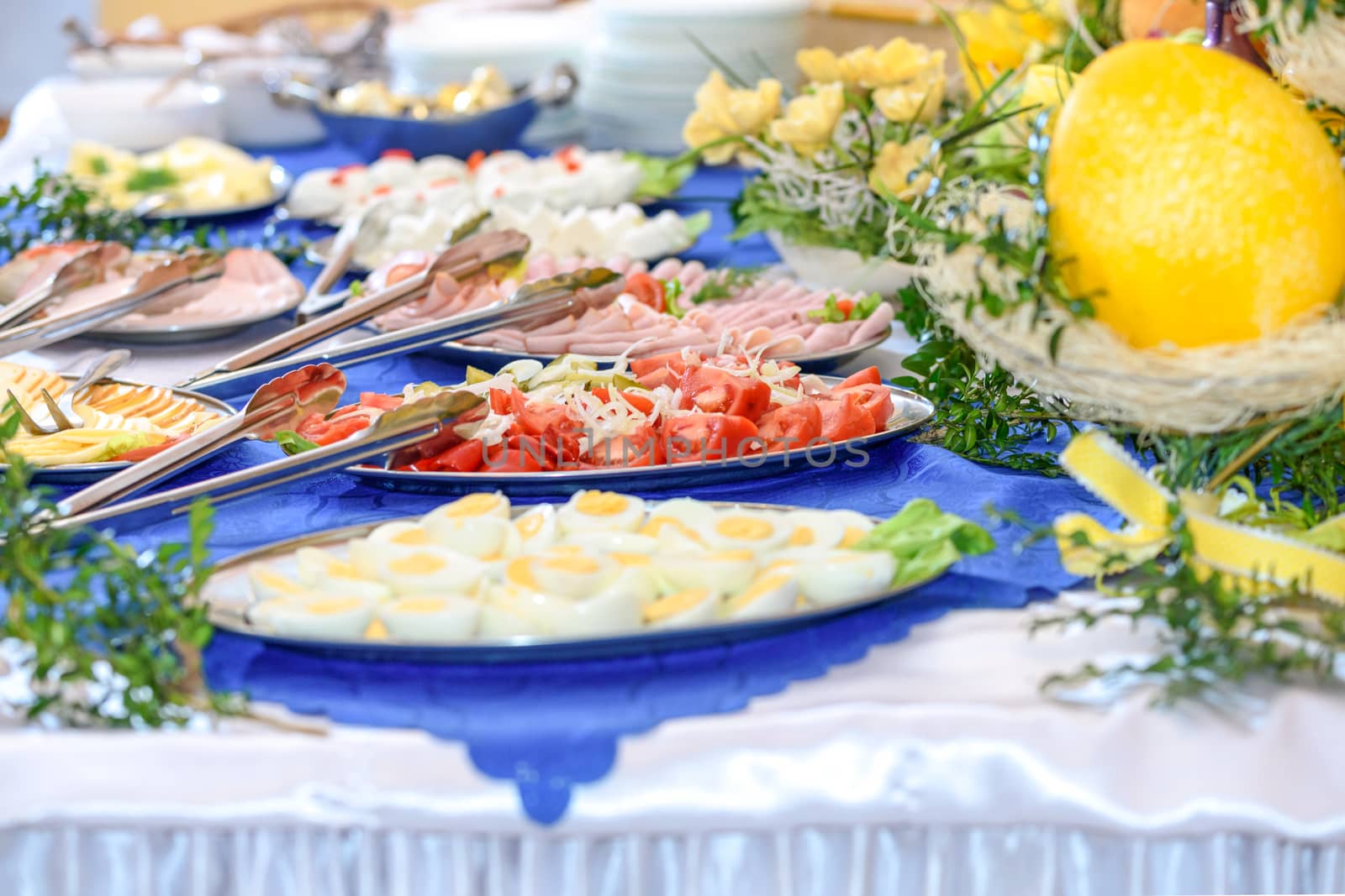 Luxurious Easter table setting full of greenery and flowers in the hotel