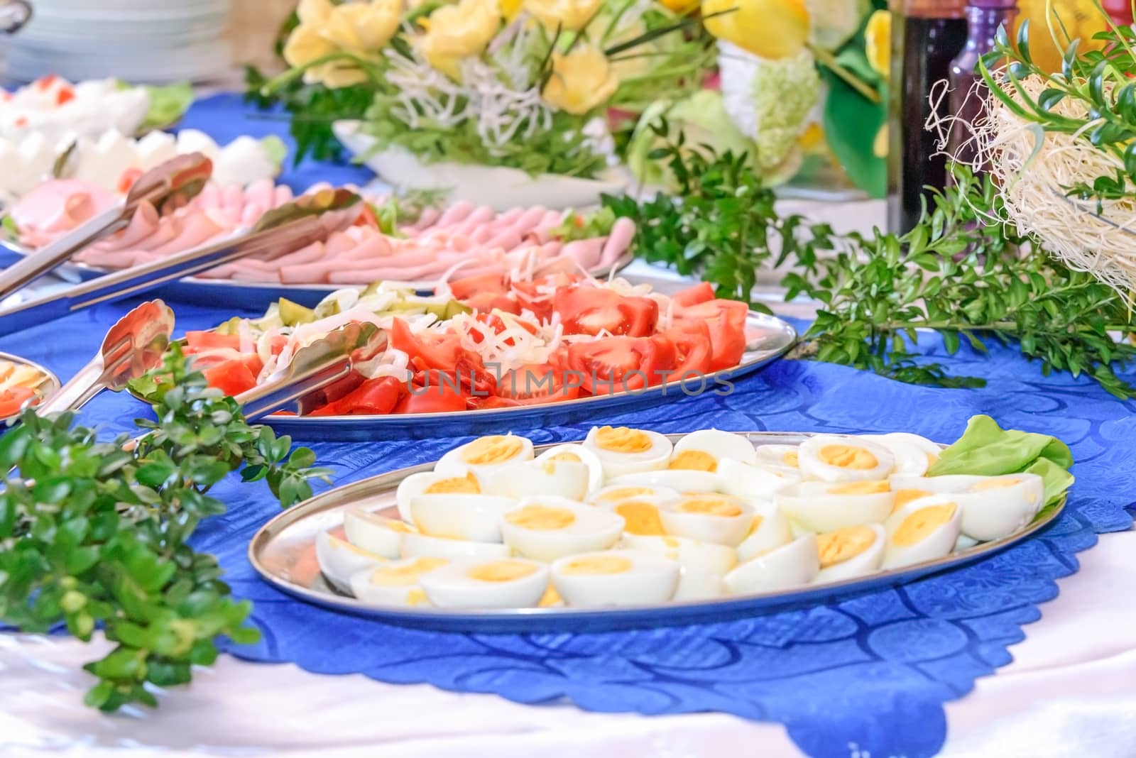 Luxurious Easter table setting full of greenery and flowers in the hotel