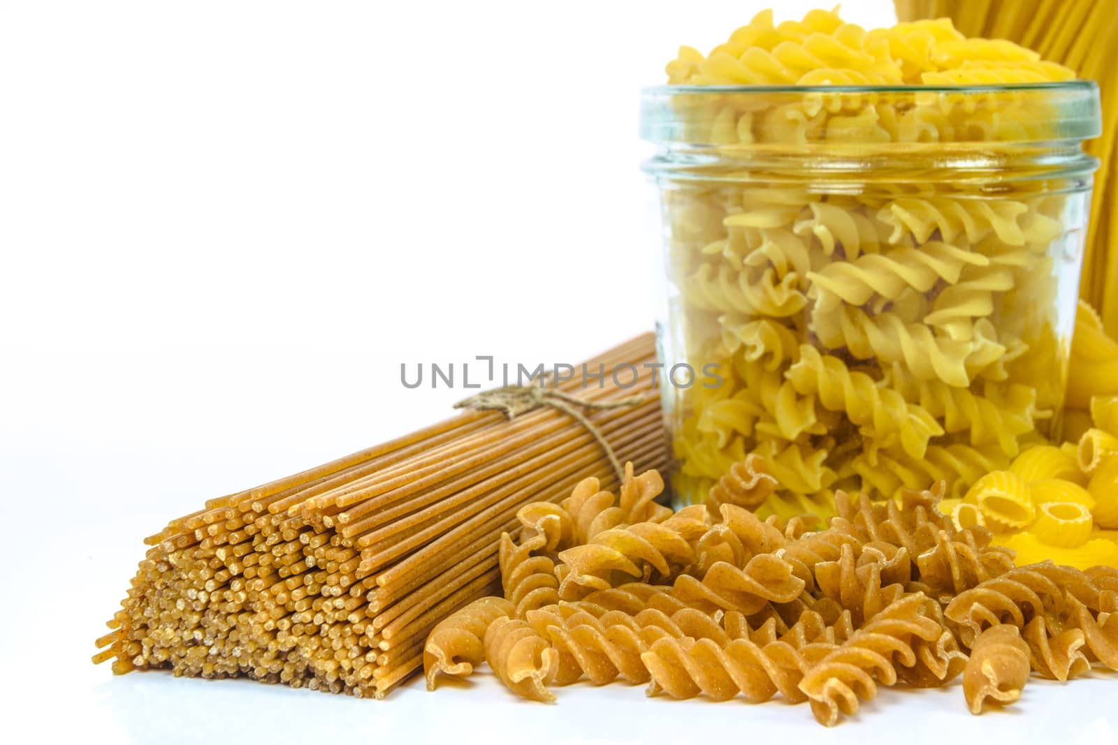 Mixed uncooked raw italian pasta isolated on white background