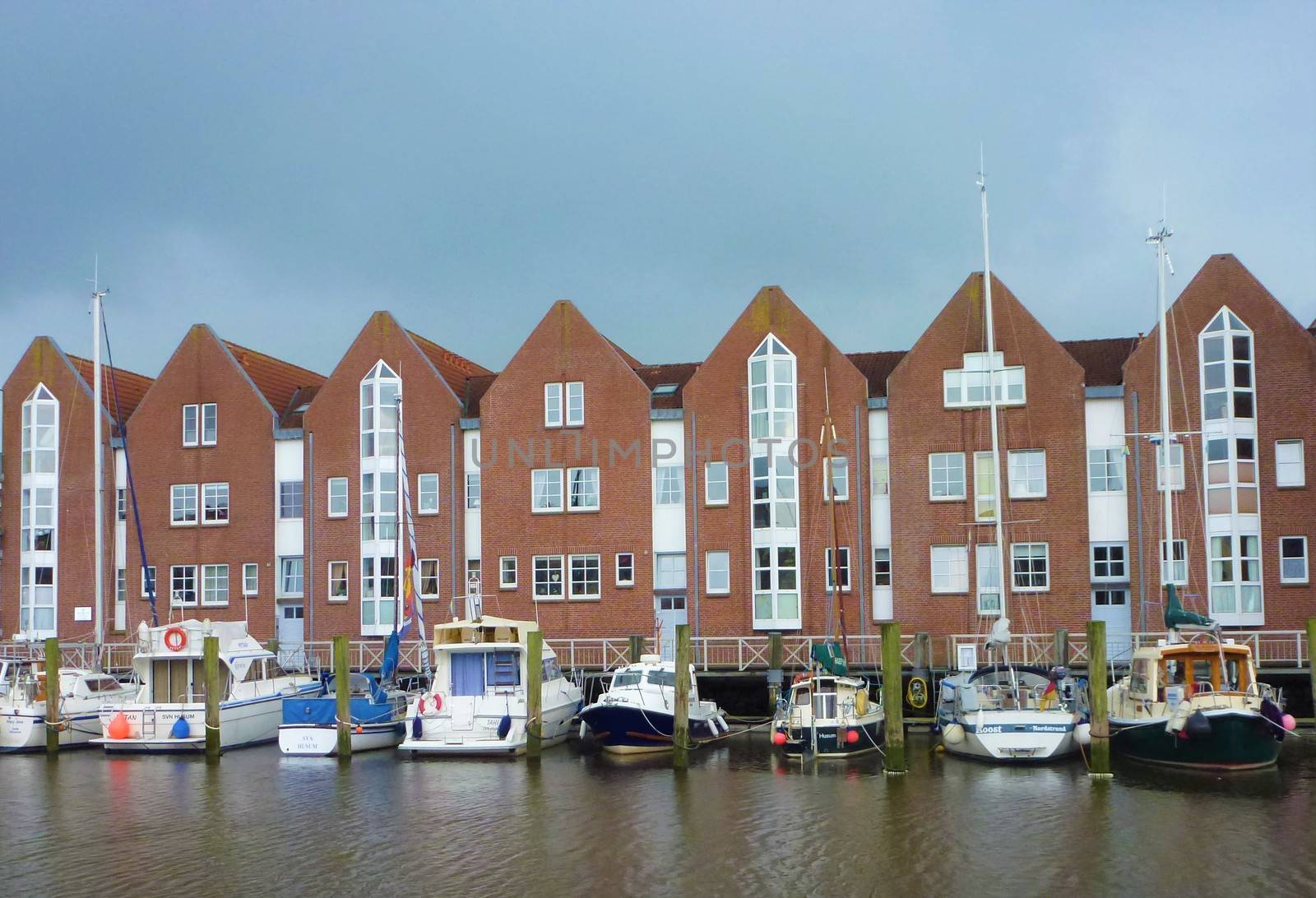 Port of Husum with boats and brick houses by pisces2386