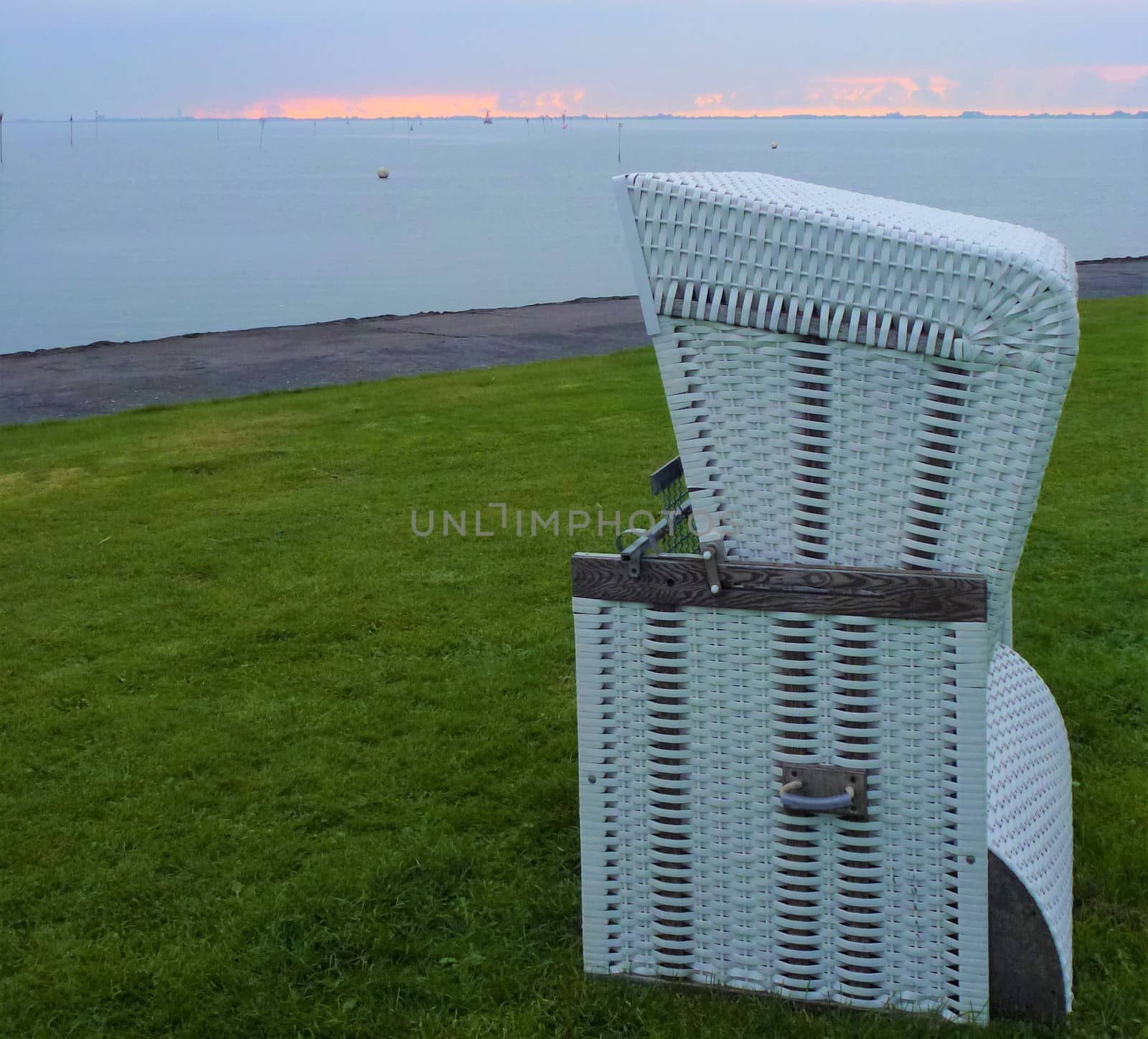 A single beach chair on the green meadow