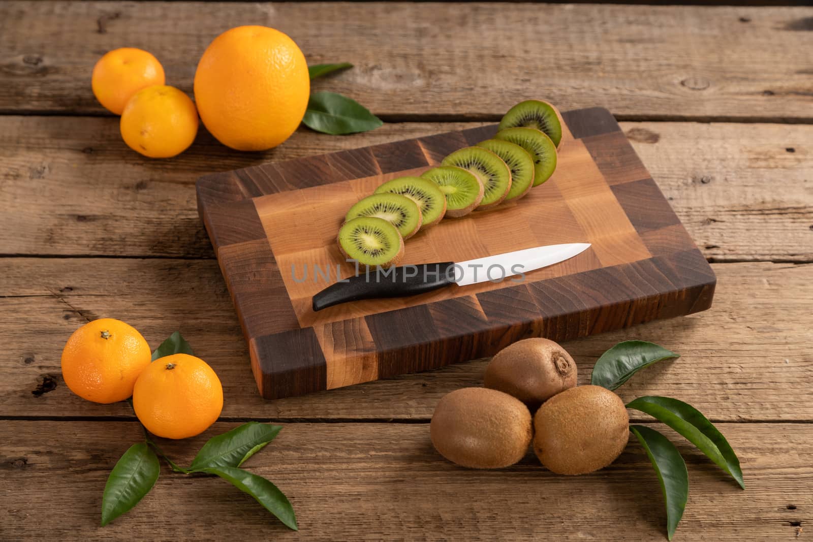 Fruit with knife on wooden cutting board by sveter