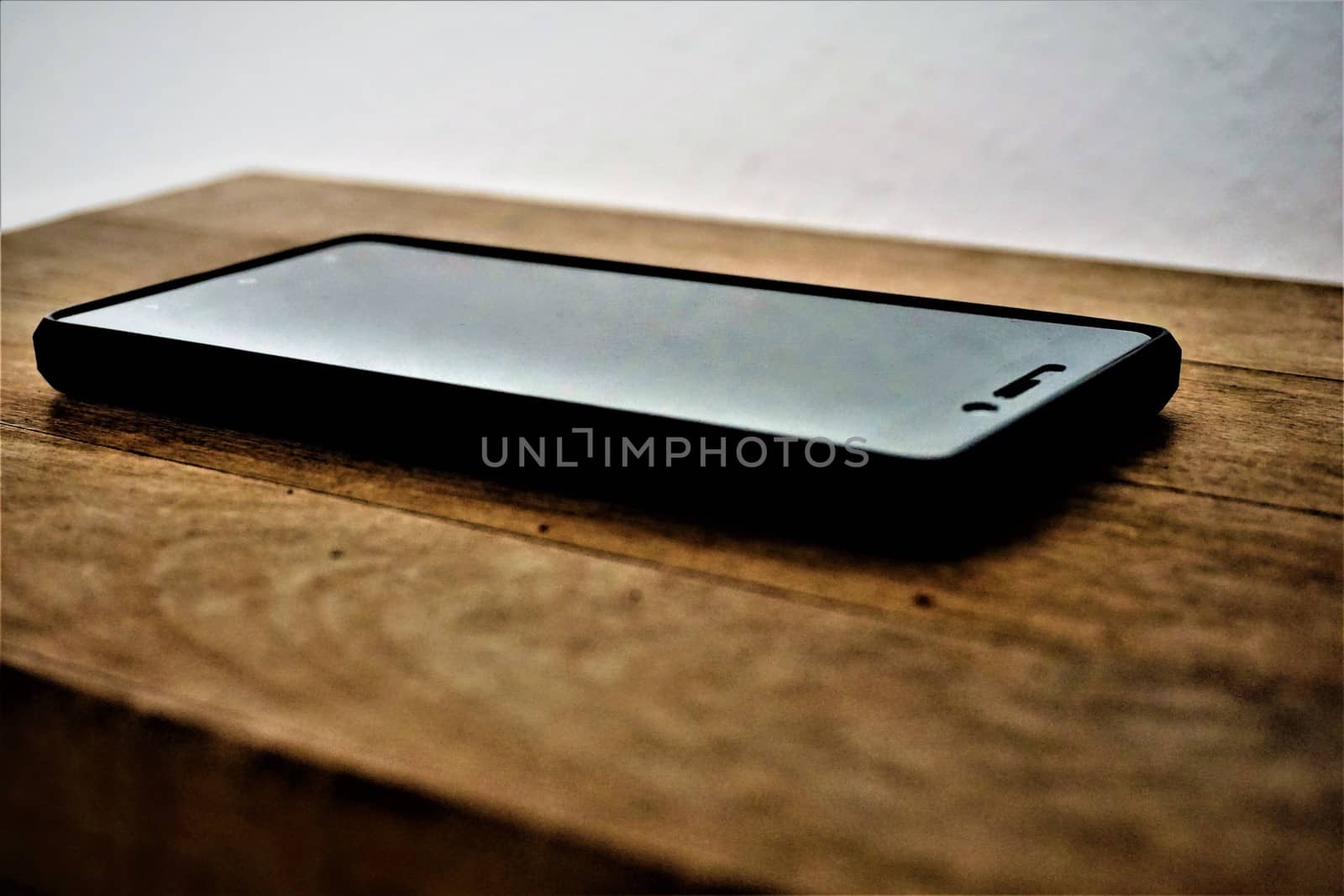 Smartphone on wooden table by pisces2386