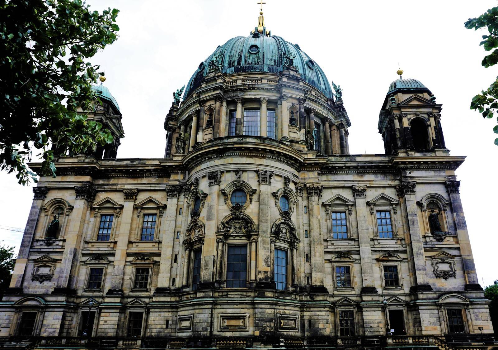 The Berlin cathedral behind trees by pisces2386