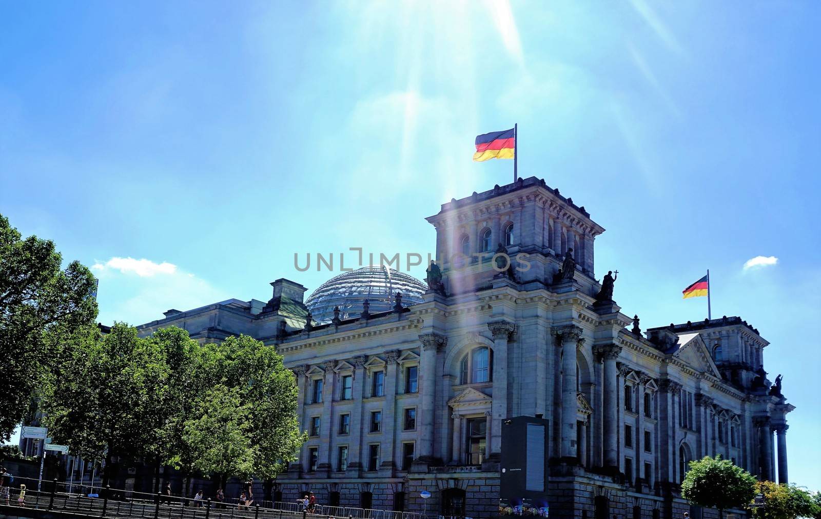 Reichstag building with trees on sunny day by pisces2386