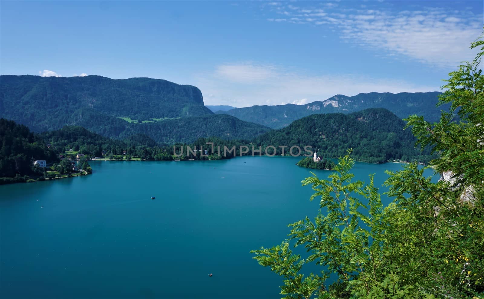 Lake and island Bled, Slovenia with hills and Pletna boats