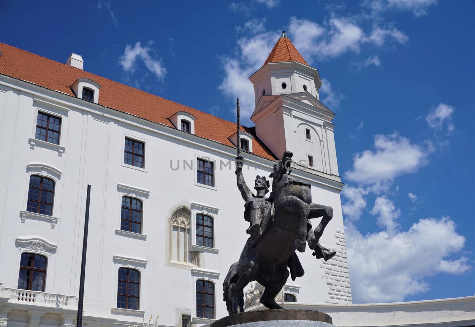 Bratislava castle and statue in front of blue sky in summer