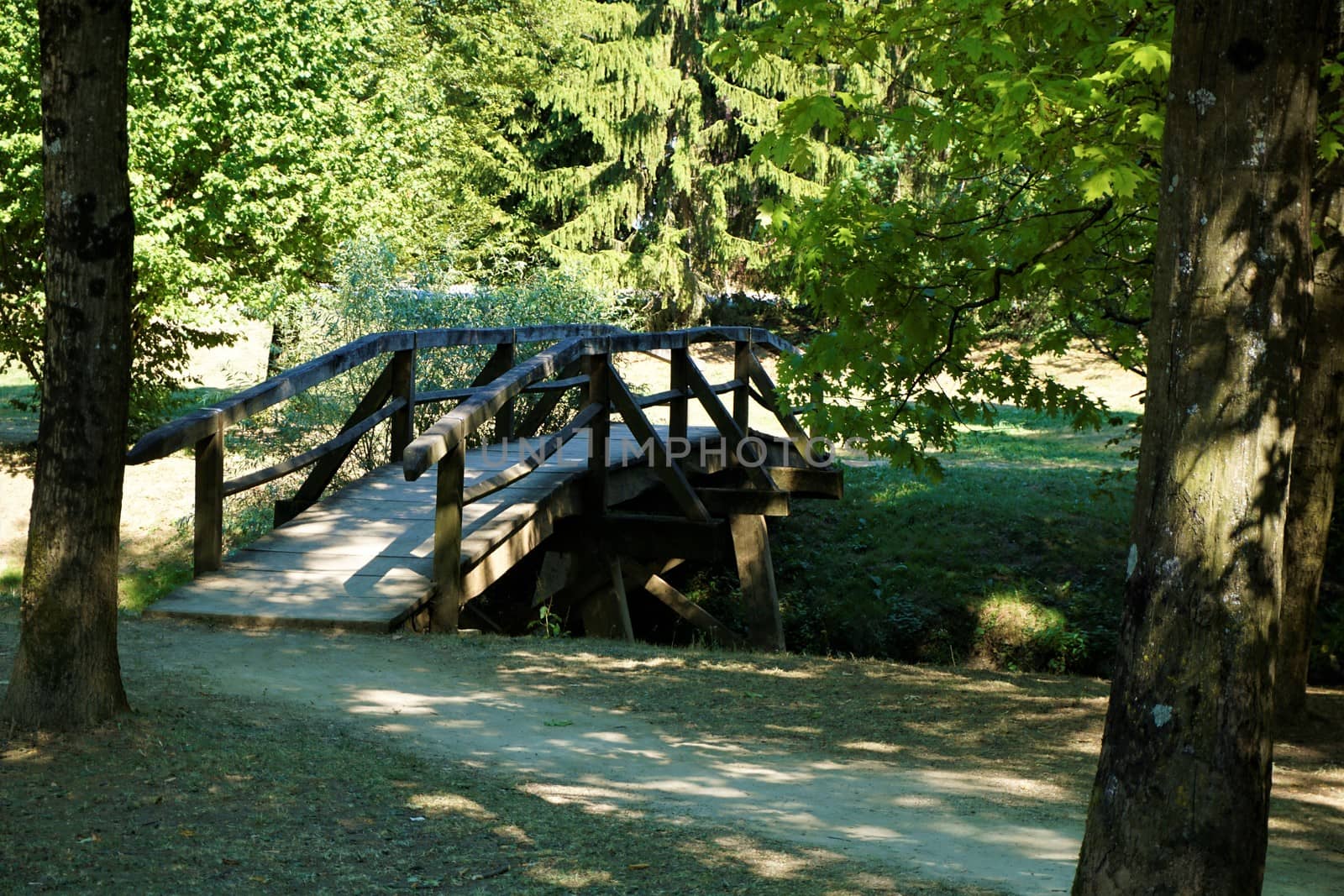 Small bridge over the Krka river in Kostanjevica na Krki by pisces2386