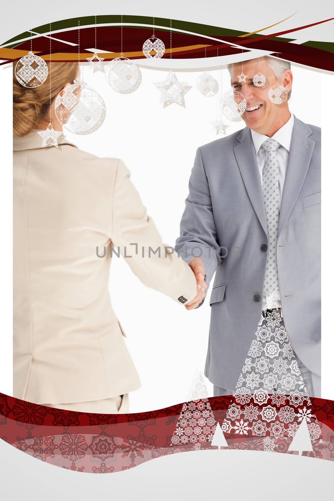 Happy business people shaking hands against christmas frame