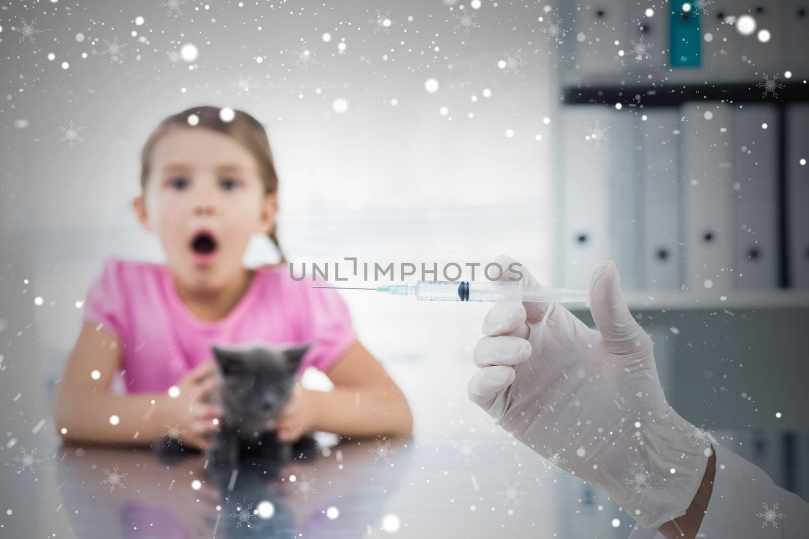 Composite image of vet holding syringe with socked girl holding kitten by Wavebreakmedia