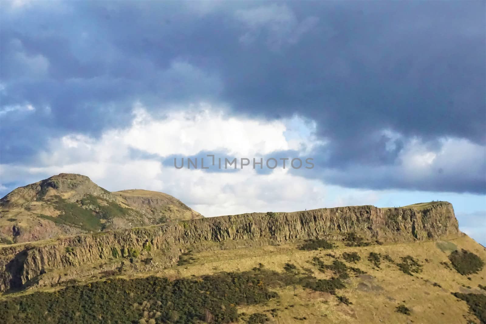 View from Calton Hill to Arthurs seat Edinburgh, Scotland with dark clouds