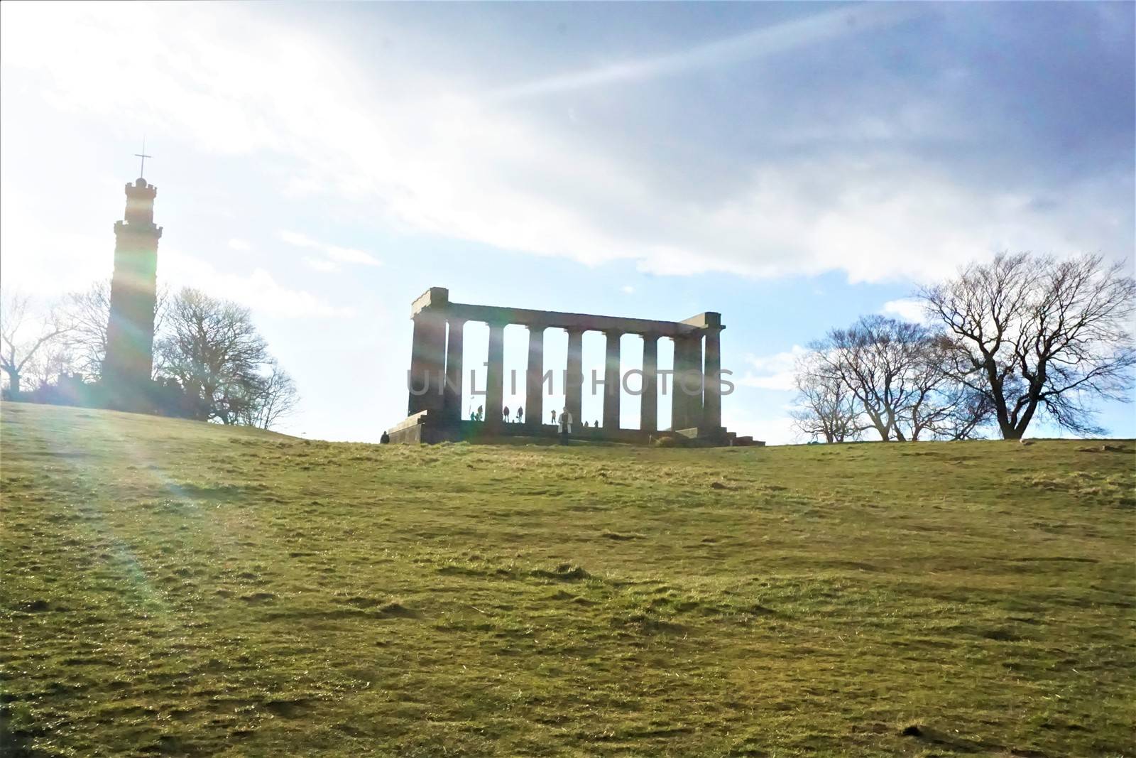 Sun over Calton Hill Edinburgh, Scotland and National Monument