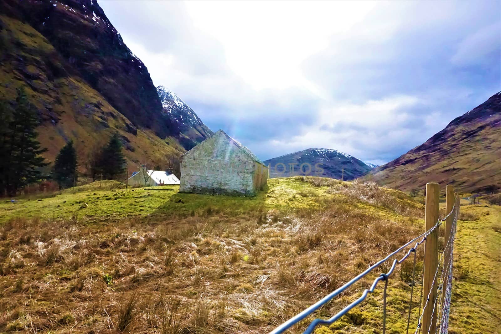 Sunny highland view with shed and fence in Ballaculish, Scotland