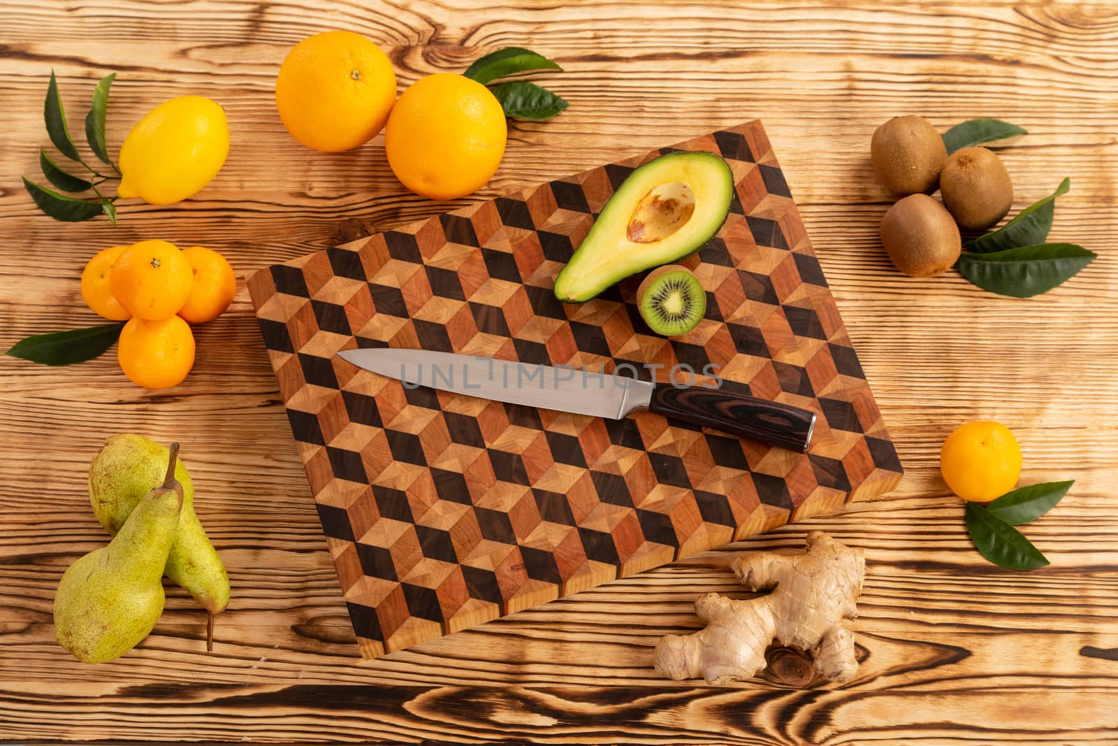 Fruit with knife on wooden cutting board by sveter