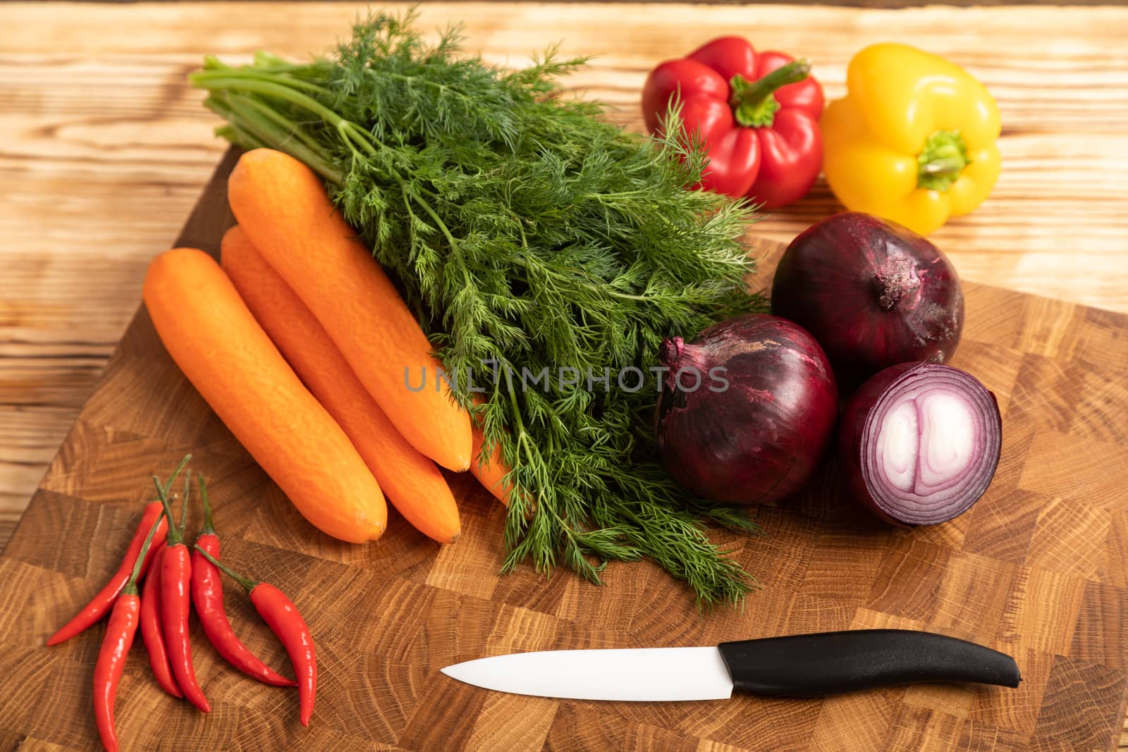 Raw chicken and vegetables on a wooden cutting board by sveter