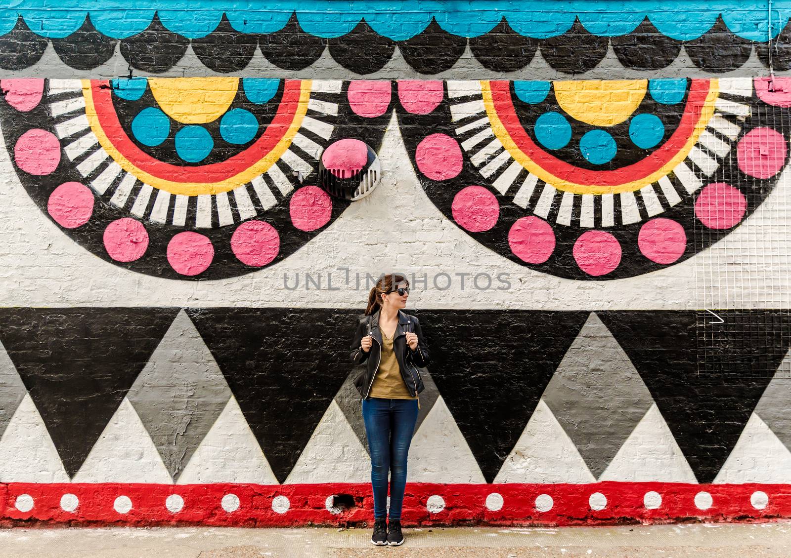 Beautiful woman in front of a colored wall