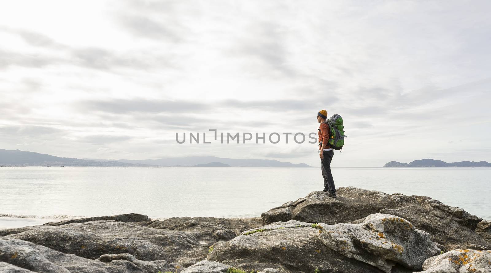 Man exploring the coast by Iko