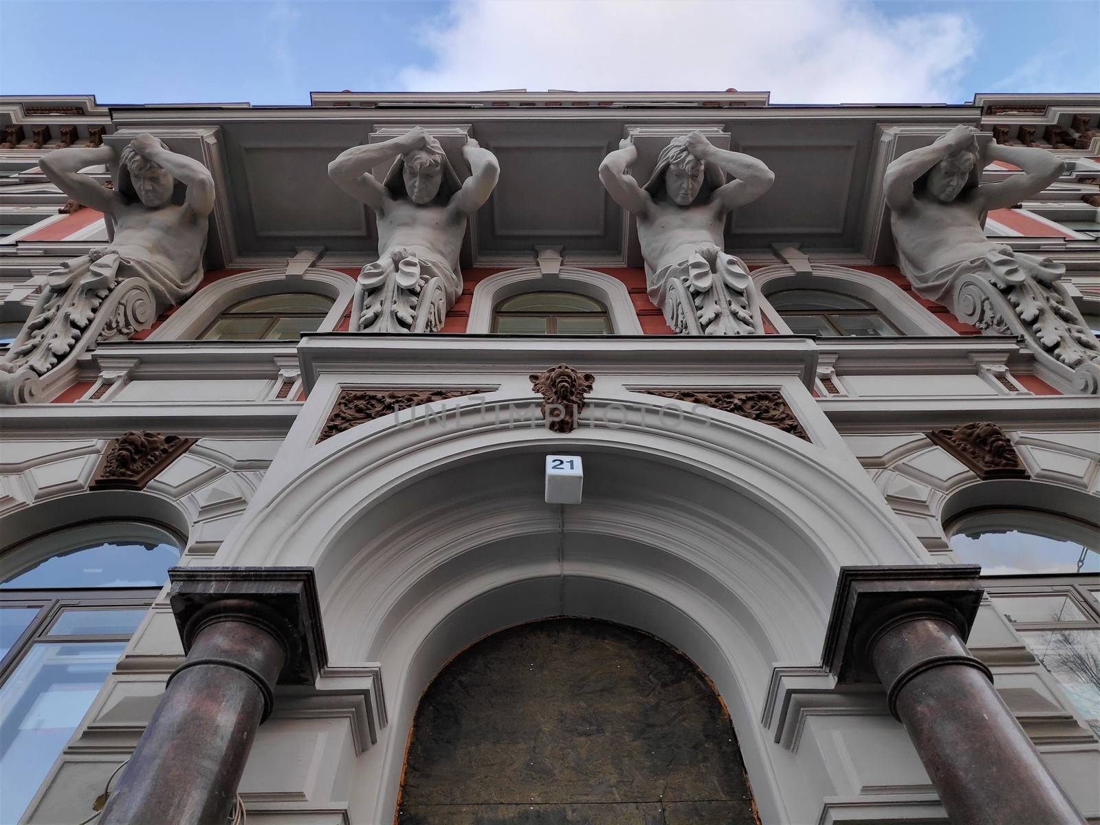 Statues of strong men carrying the balcony of a art nouveau house in Helsinki by pisces2386