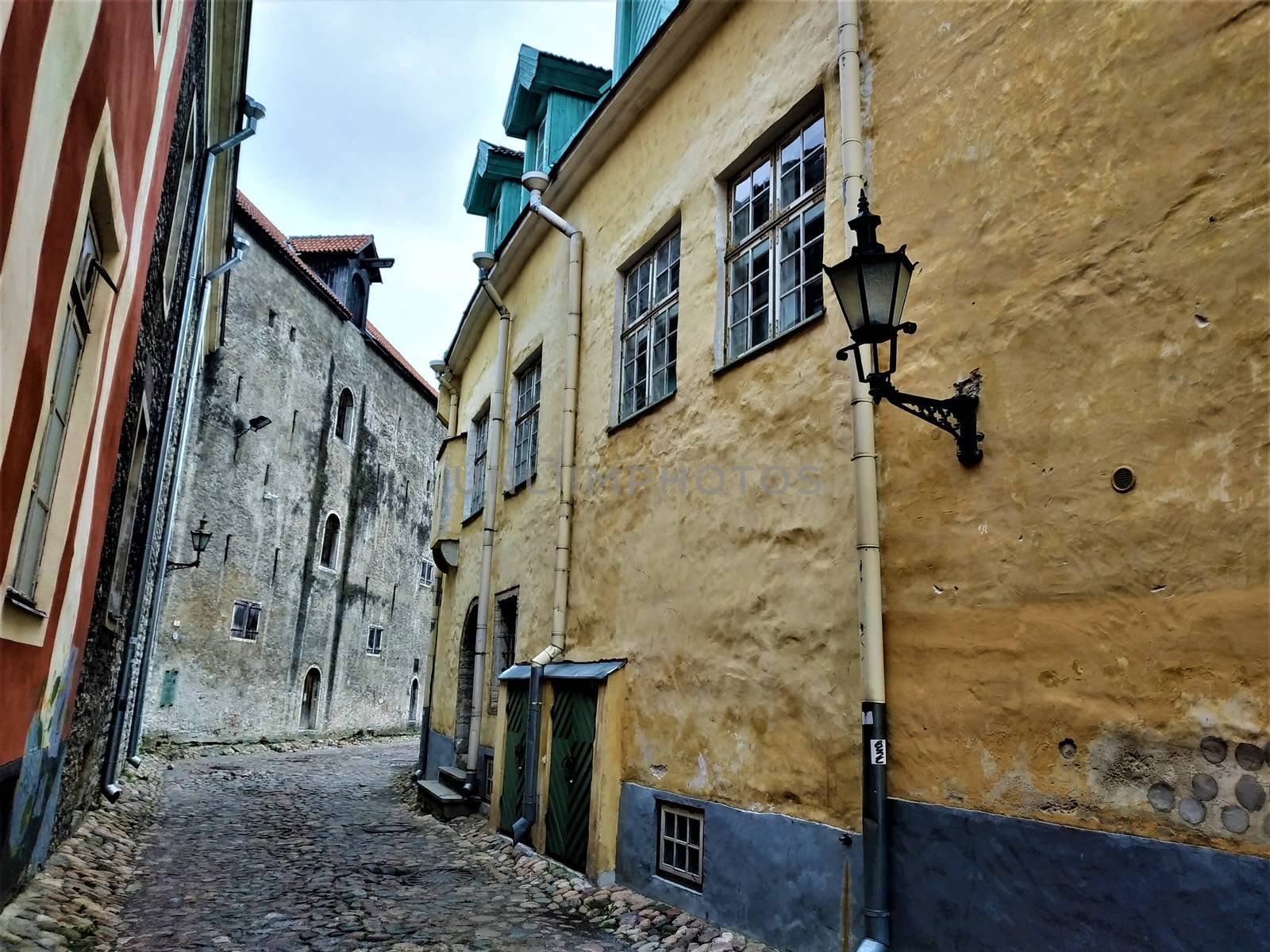 Beautiful old cobblestone street with colorful houses in Tallinn, Estonia